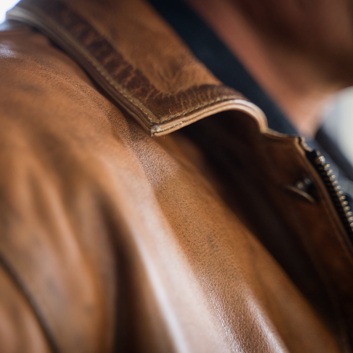 closeup of the collar of our brown full grain zip and button front closure with slip hand pockets and chest pockets