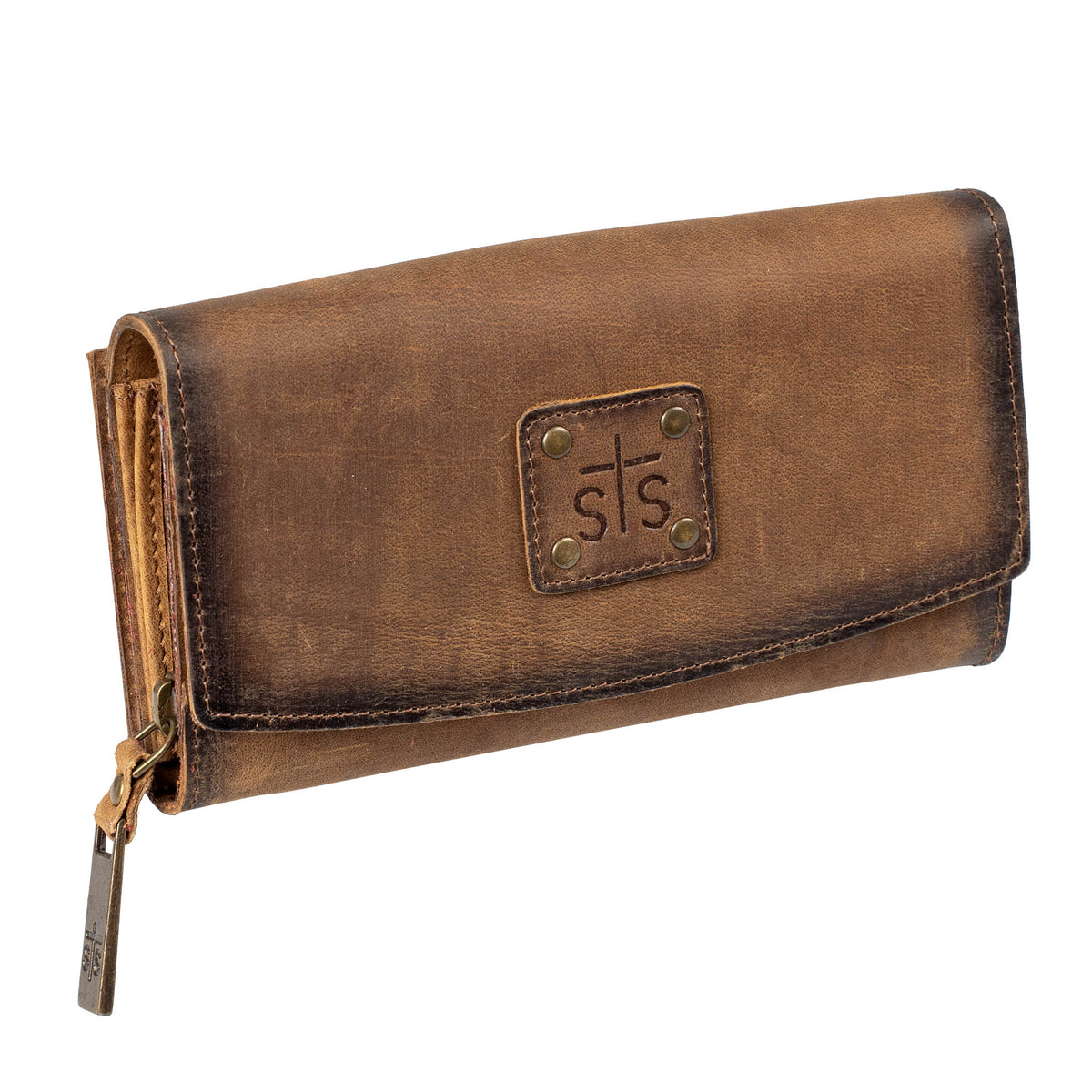 Brown leather trifold wallet with leather flap closure and zipper closure and "STS" stamped on a leather patch with a white background.