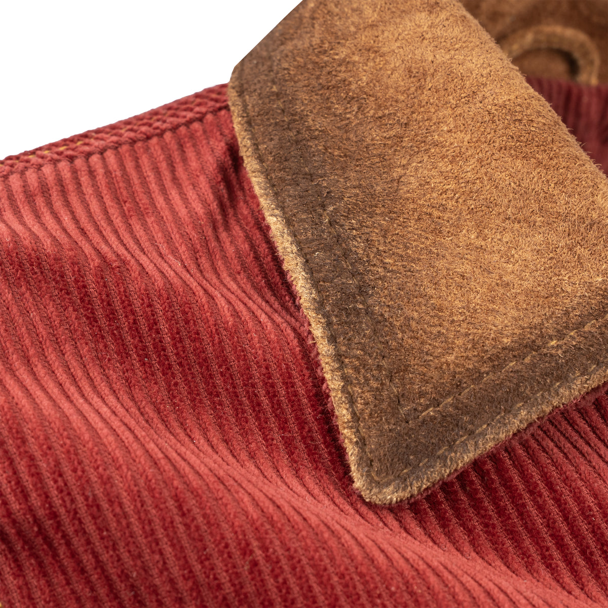 closeup of the collar of our red cotton corduroy snap closure jacket with two chest pockets and leather collar details on white background
