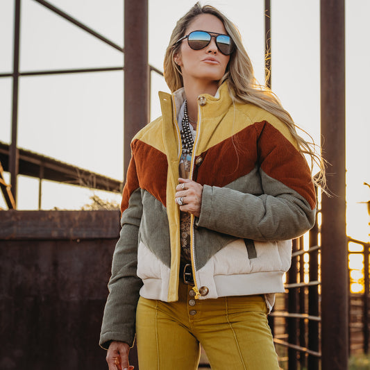 Terryn Cooper wearing our cotton color block bomber with zip and button closure outside 