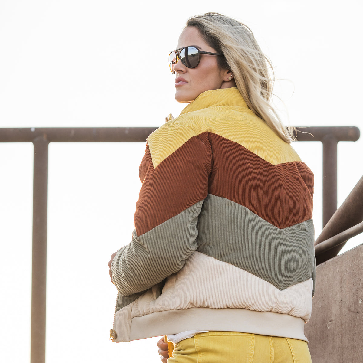 Terryn Cooper wearing our cotton color block bomber with zip and button closure outside 