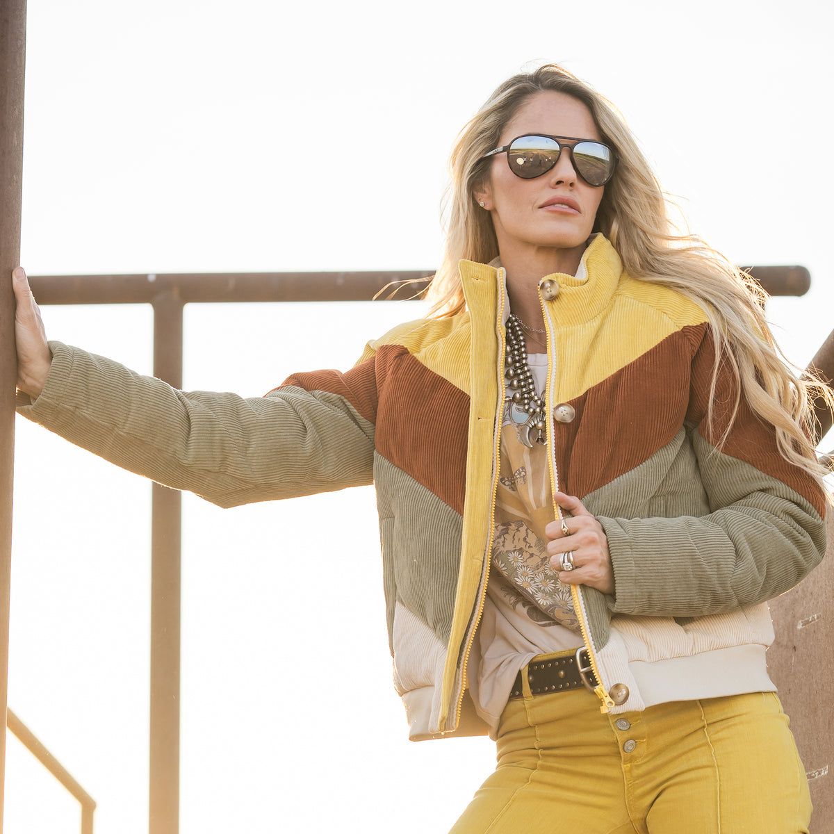 Terryn Cooper wearing our cotton color block bomber with zip and button  closure outside 