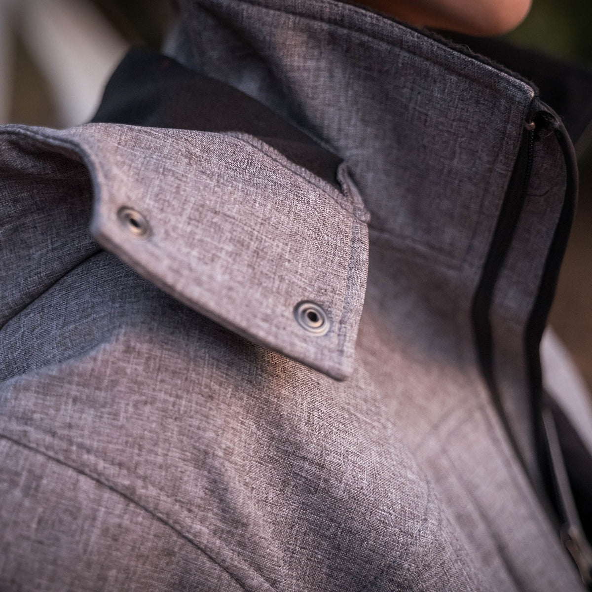 Detail of removable hood on gray softshell jacket.