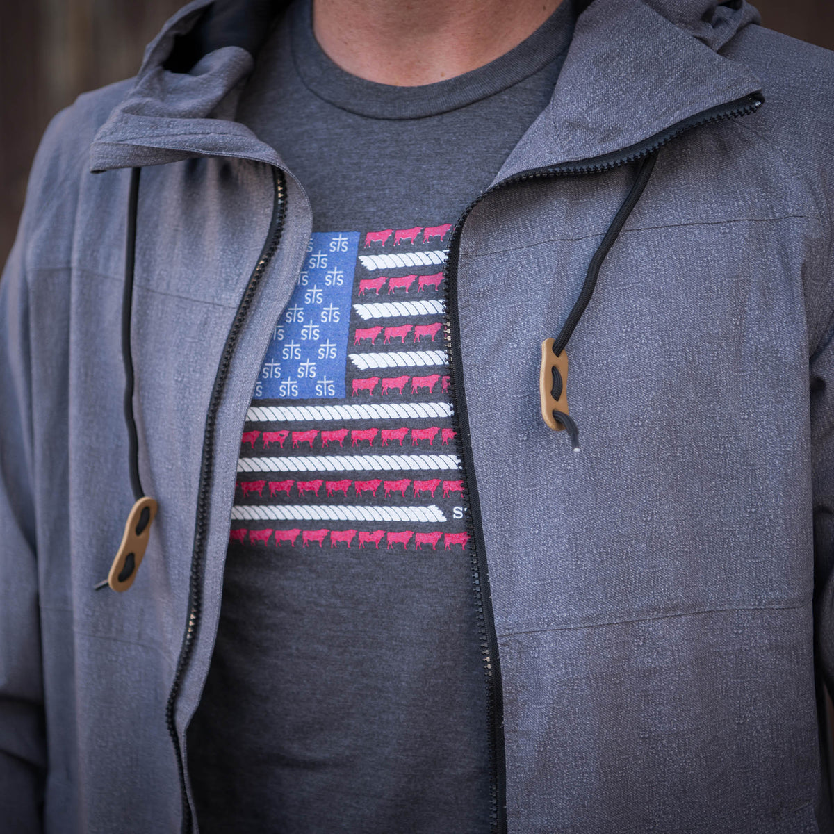 Detail of zipper and drawstrings on a heather gray men's rain jacket.