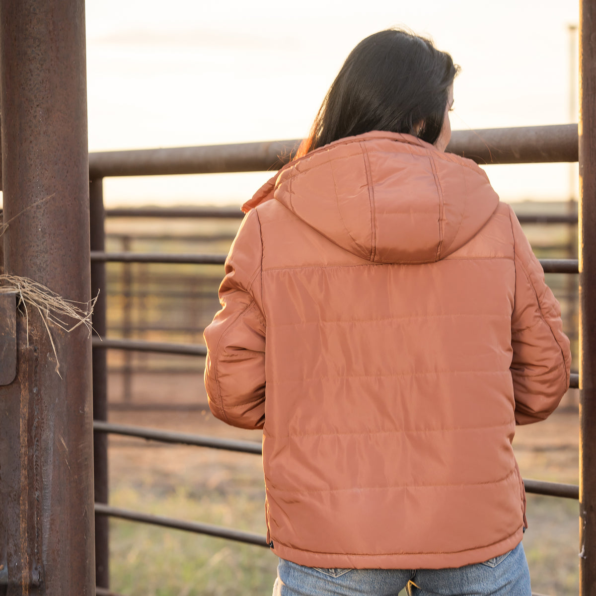 Back of Whitney Vest wearing our rust collared puffer jacket with a removable hood outside.