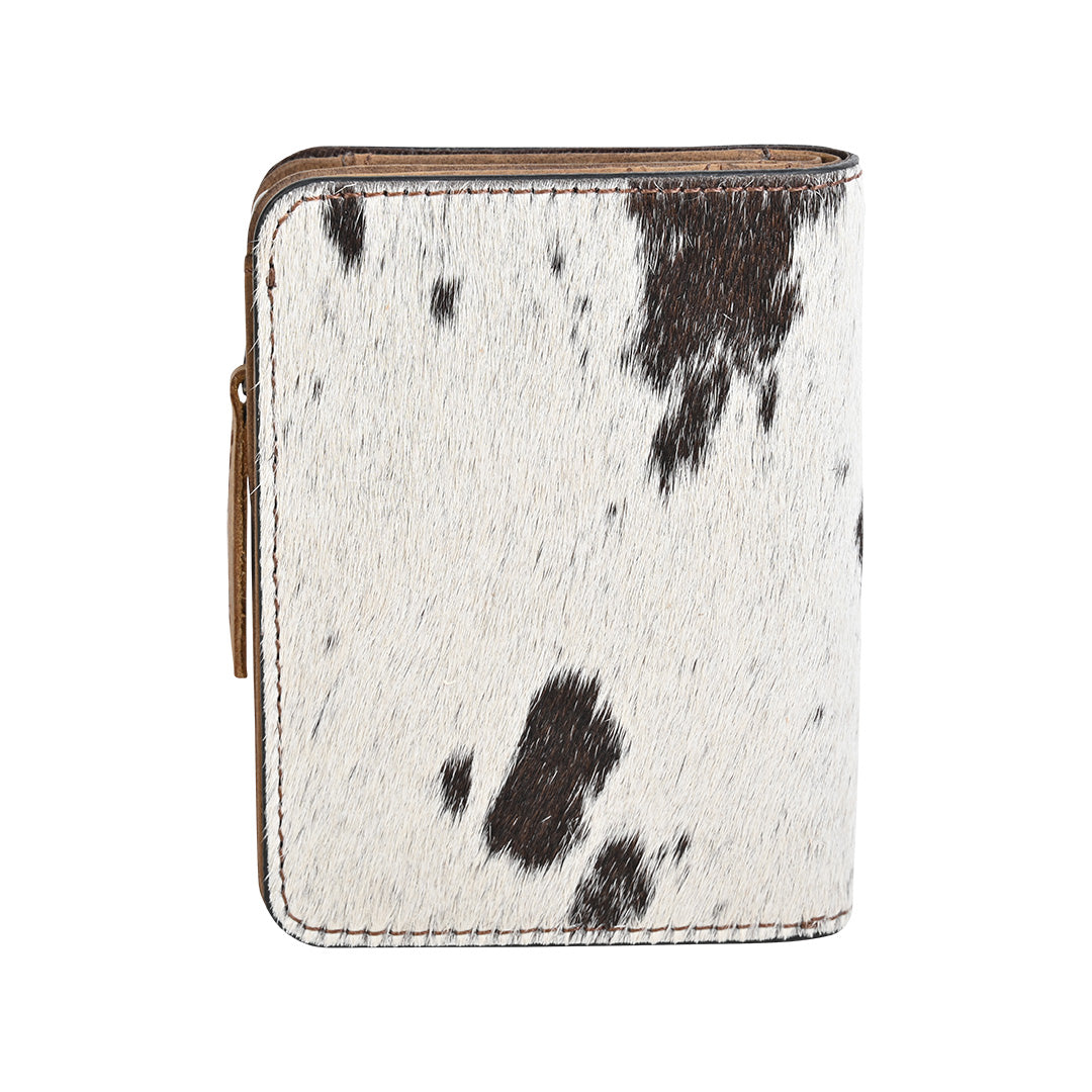 A wallet with brown and white hair on hide cowhide and zip around closure on a white background.